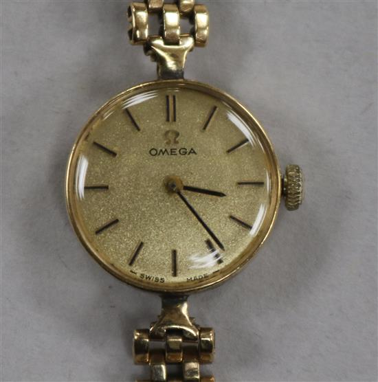 A ladys 9ct gold Omega manual wind wrist watch, on 9ct gold bracelet.